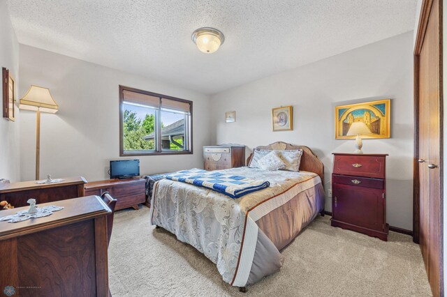 525 20 1/2 Ave E, West Fargo, ND 58078 - bedroom featuring light carpet and a textured ceiling