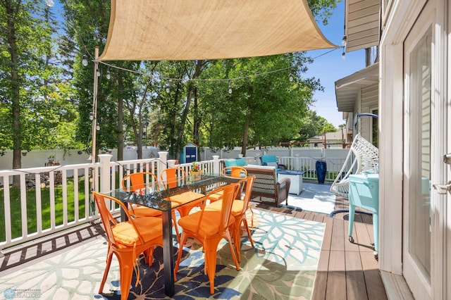 525 20 1/2 Ave E, West Fargo, ND 58078 - fenced backyard featuring outdoor dining area and a wooden deck