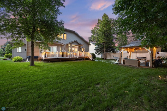 525 20 1/2 Ave E, West Fargo, ND 58078 - back of property at dusk with an outdoor hangout area, a gazebo, a deck, and a patio area
