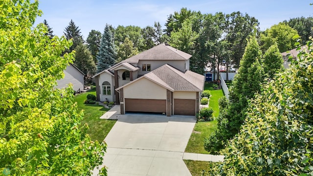 525 20 1/2 Ave E, West Fargo, ND 58078 - view of front facade with a garage, driveway, a front lawn, a shingled roof, and brick siding