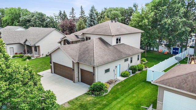 525 20 1/2 Ave E, West Fargo, ND 58078 - view of side of property with a shingled roof, a fenced backyard, an attached garage, and concrete driveway