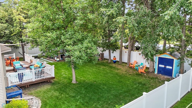 525 20 1/2 Ave E, West Fargo, ND 58078 - fenced backyard featuring a storage unit and a wooden deck