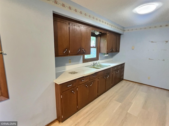 1938 149th Ave NE, Ham Lake, MN 55304 - kitchen featuring light countertops, light wood-type flooring, and dark brown cabinets