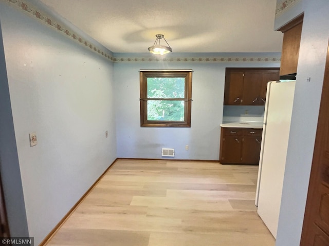 1938 149th Ave NE, Ham Lake, MN 55304 - unfurnished dining area with light wood finished floors and baseboards