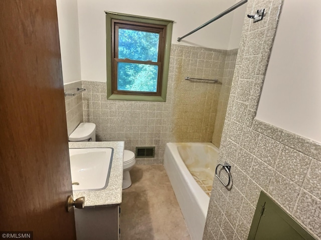 1938 149th Ave NE, Ham Lake, MN 55304 - full bathroom with tile walls, vanity, wainscoting, and shower / bathtub combination