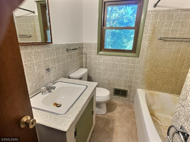 1938 149th Ave NE, Ham Lake, MN 55304 - bathroom featuring tile walls, vanity, and wainscoting