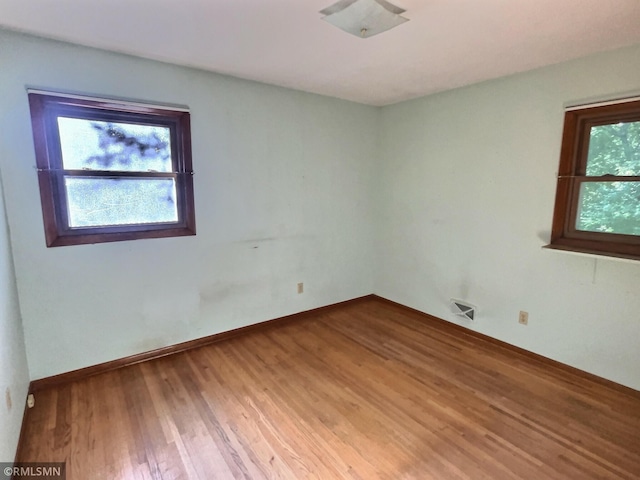 1938 149th Ave NE, Ham Lake, MN 55304 - unfurnished room with wood finished floors and baseboards