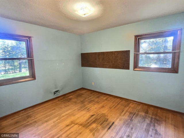 1938 149th Ave NE, Ham Lake, MN 55304 - unfurnished room featuring wood finished floors and a textured ceiling