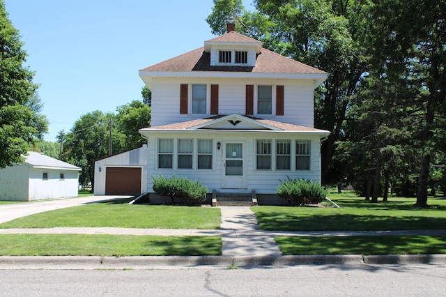 201 3rd St SE, Renville, MN 56284 - traditional style home featuring concrete driveway, roof with shingles, a front yard, and a chimney