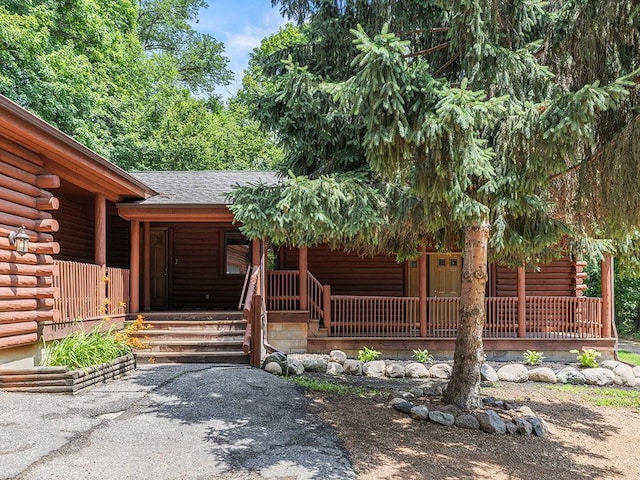 20980 Parkfield Ave, Spring Lake Twp, MN 55352 - view of front facade with a porch, log siding, and a shingled roof