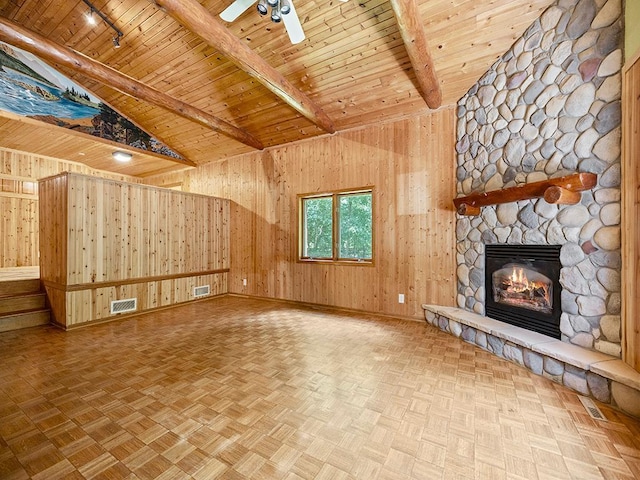 20980 Parkfield Ave, Spring Lake Twp, MN 55352 - unfurnished living room featuring wooden walls, wooden ceiling, a fireplace, a ceiling fan, and track lighting