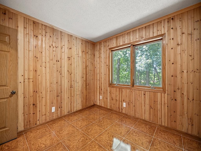 20980 Parkfield Ave, Spring Lake Twp, MN 55352 - unfurnished room featuring a textured ceiling, wood walls, and tile patterned floors
