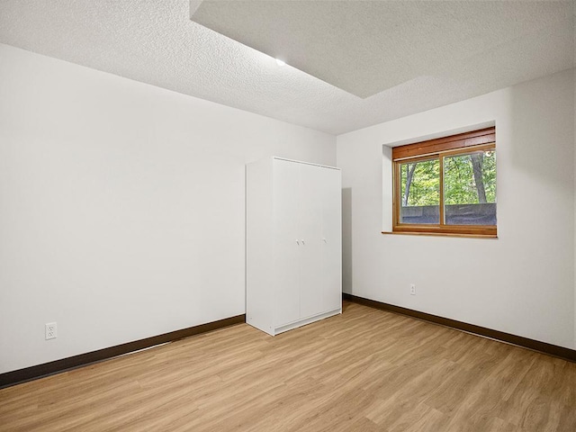 20980 Parkfield Ave, Spring Lake Twp, MN 55352 - unfurnished room with light wood-style floors and a textured ceiling