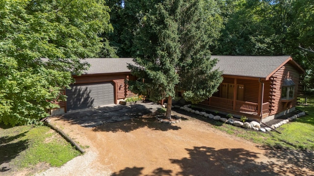 20980 Parkfield Ave, Spring Lake Twp, MN 55352 - cabin with driveway, log exterior, a porch, a garage, and roof with shingles