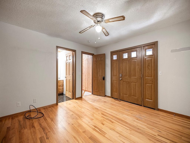 20980 Parkfield Ave, Spring Lake Twp, MN 55352 - foyer featuring light wood-style flooring, a ceiling fan, and a textured ceiling