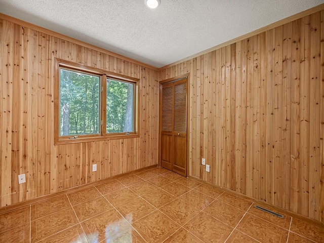 20980 Parkfield Ave, Spring Lake Twp, MN 55352 - empty room with a textured ceiling, wood walls, and tile patterned floors