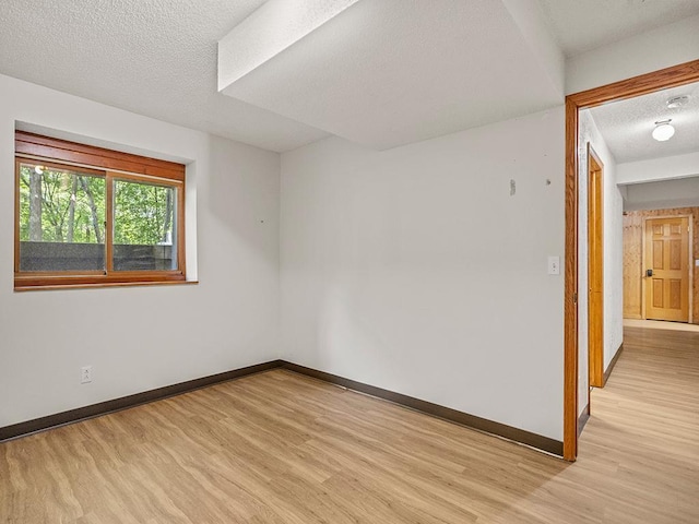 20980 Parkfield Ave, Spring Lake Twp, MN 55352 - empty room with light wood-type flooring, a textured ceiling, and a smoke detector