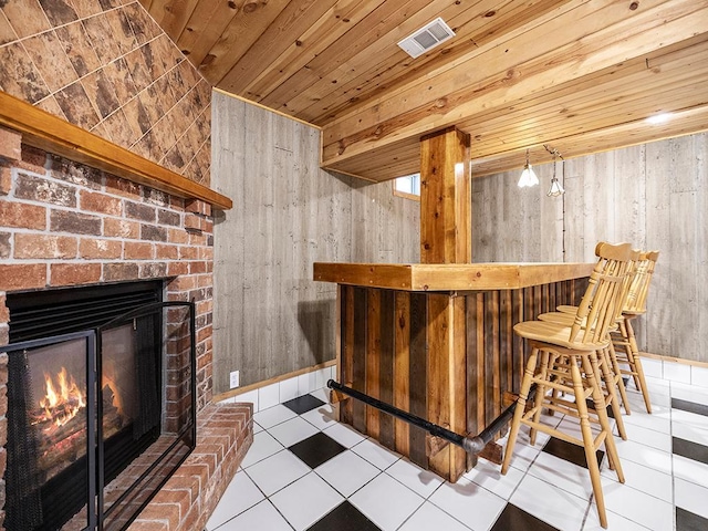 20980 Parkfield Ave, Spring Lake Twp, MN 55352 - indoor dry bar with wooden ceiling, wood walls, a brick fireplace, and tile patterned floors