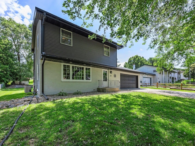 724 2nd Ave S, Buffalo, MN 55313 - view of front of home featuring asphalt driveway, a garage, and brick siding