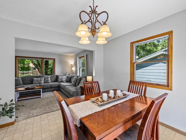 724 2nd Ave S, Buffalo, MN 55313 - dining area featuring a chandelier, light floors, and a textured ceiling