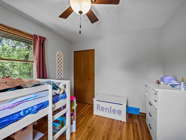 724 2nd Ave S, Buffalo, MN 55313 - bedroom with a textured ceiling, wood finished floors, and ceiling fan