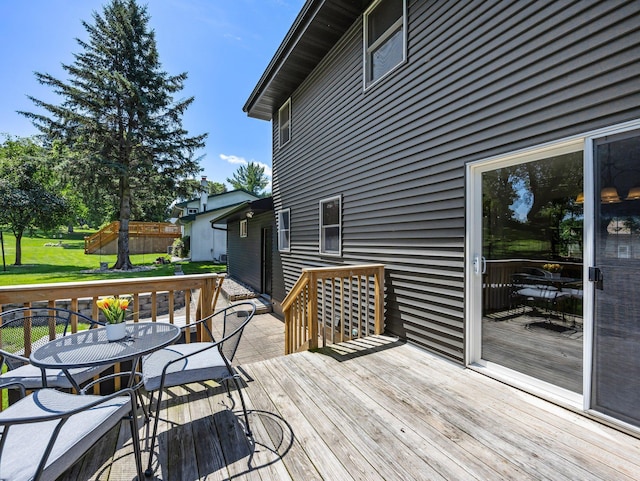 724 2nd Ave S, Buffalo, MN 55313 - deck with outdoor dining area and a lawn