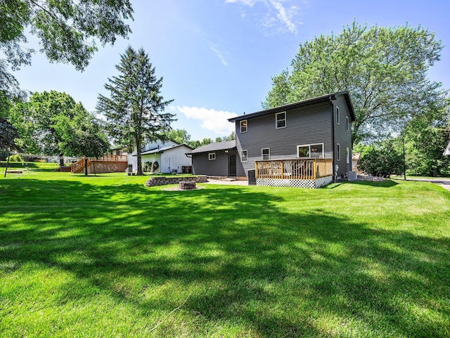 724 2nd Ave S, Buffalo, MN 55313 - rear view of house featuring a deck, a fire pit, and a lawn