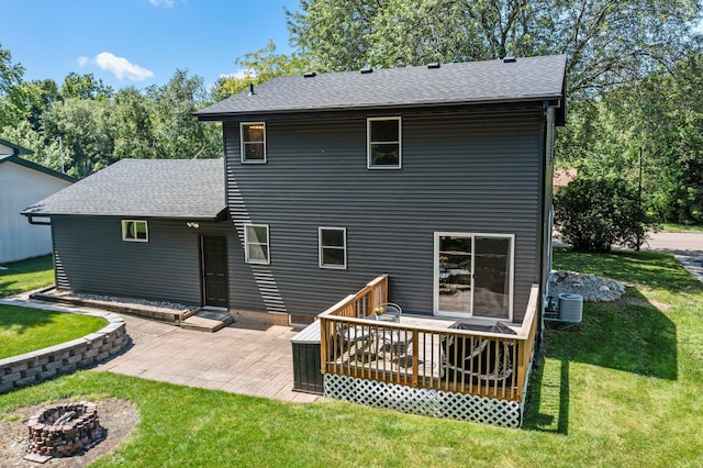 724 2nd Ave S, Buffalo, MN 55313 - back of house featuring a lawn, roof with shingles, a deck, and an outdoor fire pit