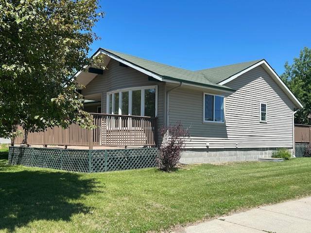 504 8th Ave, Grand Rapids, MN 55744 - view of home's exterior featuring a lawn and a deck