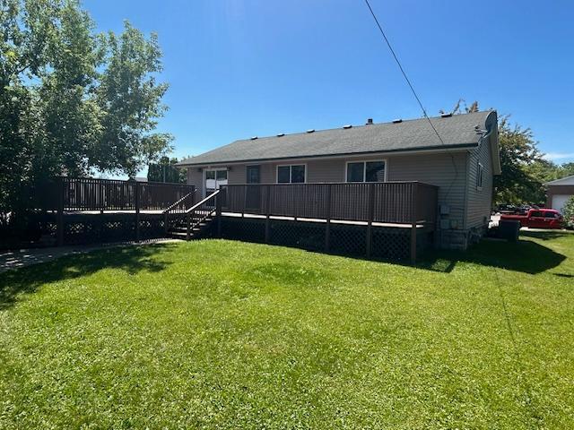 504 8th Ave, Grand Rapids, MN 55744 - rear view of house with a wooden deck and a yard