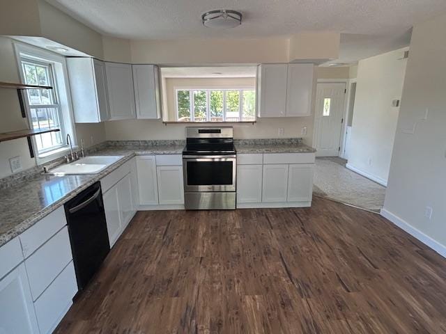 504 8th Ave, Grand Rapids, MN 55744 - kitchen with stainless steel electric range, black dishwasher, white cabinets, dark wood-style flooring, and plenty of natural light
