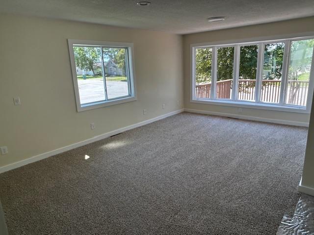 504 8th Ave, Grand Rapids, MN 55744 - spare room with baseboards and carpet floors