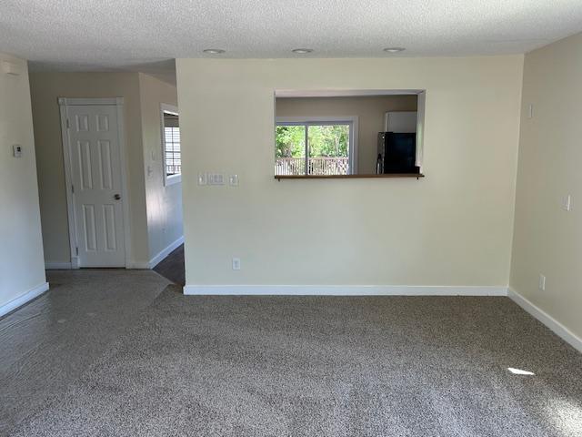 504 8th Ave, Grand Rapids, MN 55744 - empty room featuring a textured ceiling and carpet floors