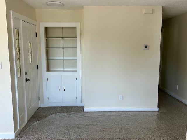 504 8th Ave, Grand Rapids, MN 55744 - unfurnished bedroom with carpet, a closet, and a textured ceiling