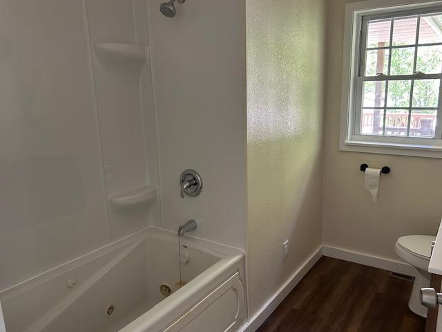 504 8th Ave, Grand Rapids, MN 55744 - bathroom with healthy amount of natural light, wood finished floors, and a combined bath / shower with jetted tub