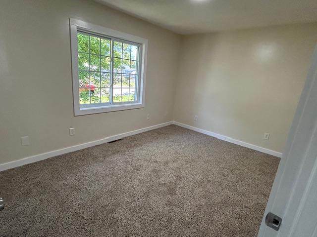 504 8th Ave, Grand Rapids, MN 55744 - carpeted empty room with baseboards