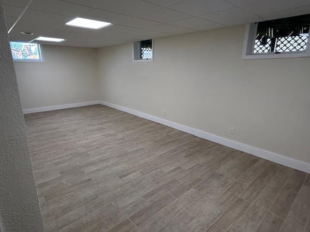 504 8th Ave, Grand Rapids, MN 55744 - below grade area with wood finished floors and a paneled ceiling