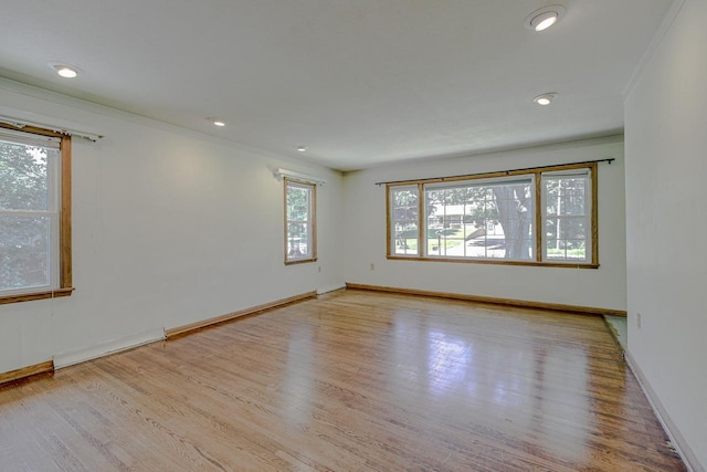 1970 Maryknoll Ave, Maplewood, MN 55109 - empty room with ornamental molding, wood finished floors, a baseboard radiator, and recessed lighting