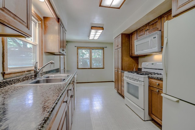 1970 Maryknoll Ave, Maplewood, MN 55109 - kitchen featuring white appliances, brown cabinets, and light flooring