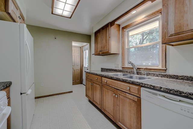 1970 Maryknoll Ave, Maplewood, MN 55109 - kitchen featuring white appliances, dark countertops, brown cabinets, and light flooring