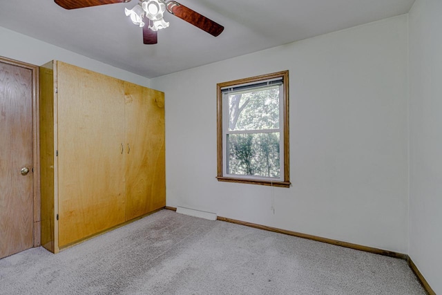 1970 Maryknoll Ave, Maplewood, MN 55109 - carpeted empty room with a ceiling fan and a baseboard radiator