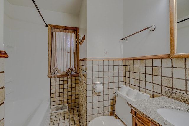 1970 Maryknoll Ave, Maplewood, MN 55109 - bathroom featuring tile walls, vanity, tile patterned floors, washtub / shower combination, and a wainscoted wall