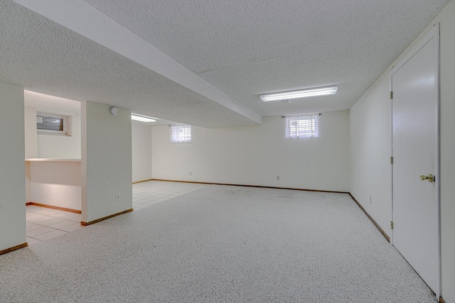 1970 Maryknoll Ave, Maplewood, MN 55109 - below grade area with a textured ceiling, light carpet, and healthy amount of natural light