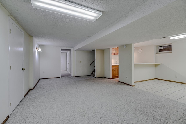 1970 Maryknoll Ave, Maplewood, MN 55109 - finished below grade area with a textured ceiling, light carpet, stairs, and light tile patterned flooring