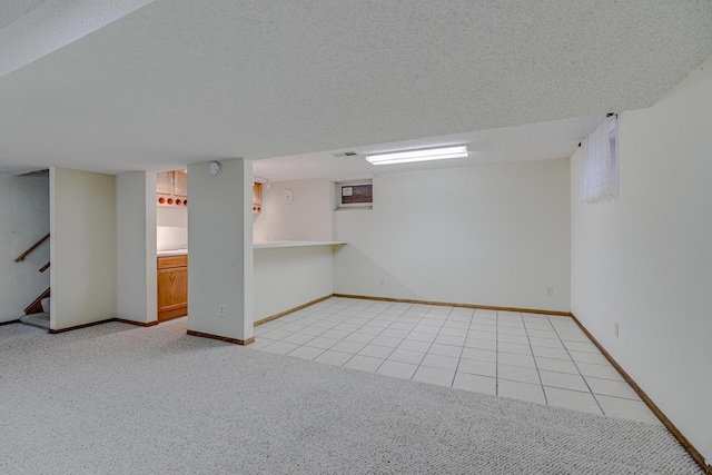 1970 Maryknoll Ave, Maplewood, MN 55109 - finished basement with light colored carpet, stairway, light tile patterned floors, and a textured ceiling