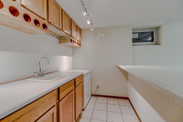 1970 Maryknoll Ave, Maplewood, MN 55109 - kitchen with light countertops, light tile patterned floors, a textured ceiling, rail lighting, and brown cabinets