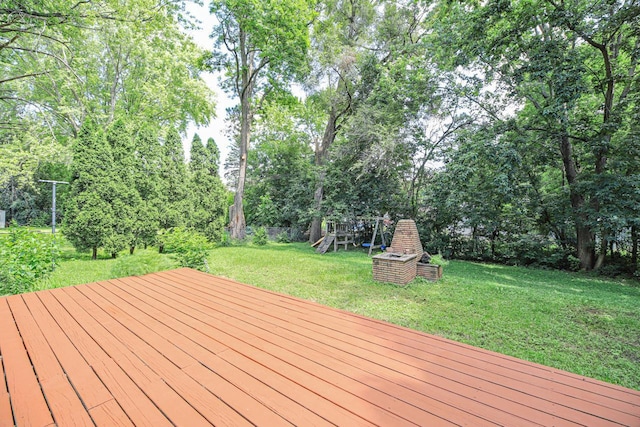1970 Maryknoll Ave, Maplewood, MN 55109 - deck featuring a lawn, a playground, and view of wooded area