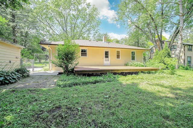 1970 Maryknoll Ave, Maplewood, MN 55109 - back of property with a deck, a chimney, and a gate