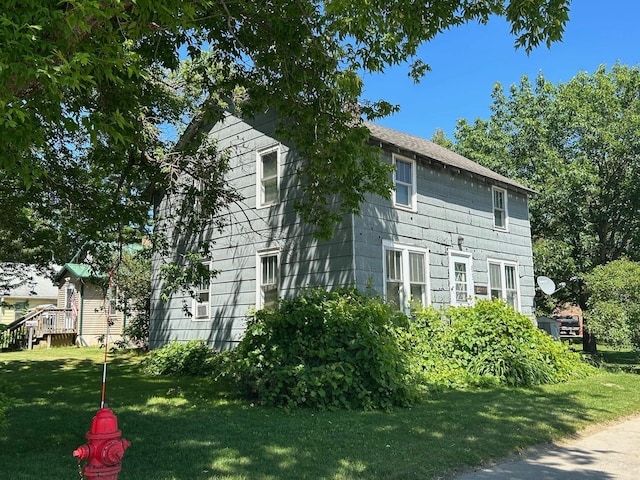 823 5th St, Grand Rapids, MN 55744 - view of side of home featuring a lawn