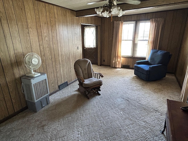 823 5th St, Grand Rapids, MN 55744 - living area featuring wooden walls, plenty of natural light, carpet floors, and a ceiling fan